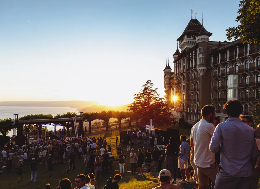 Montreux Jazz Festival: festival visitors on a lawn above Lake Geneva at sunset